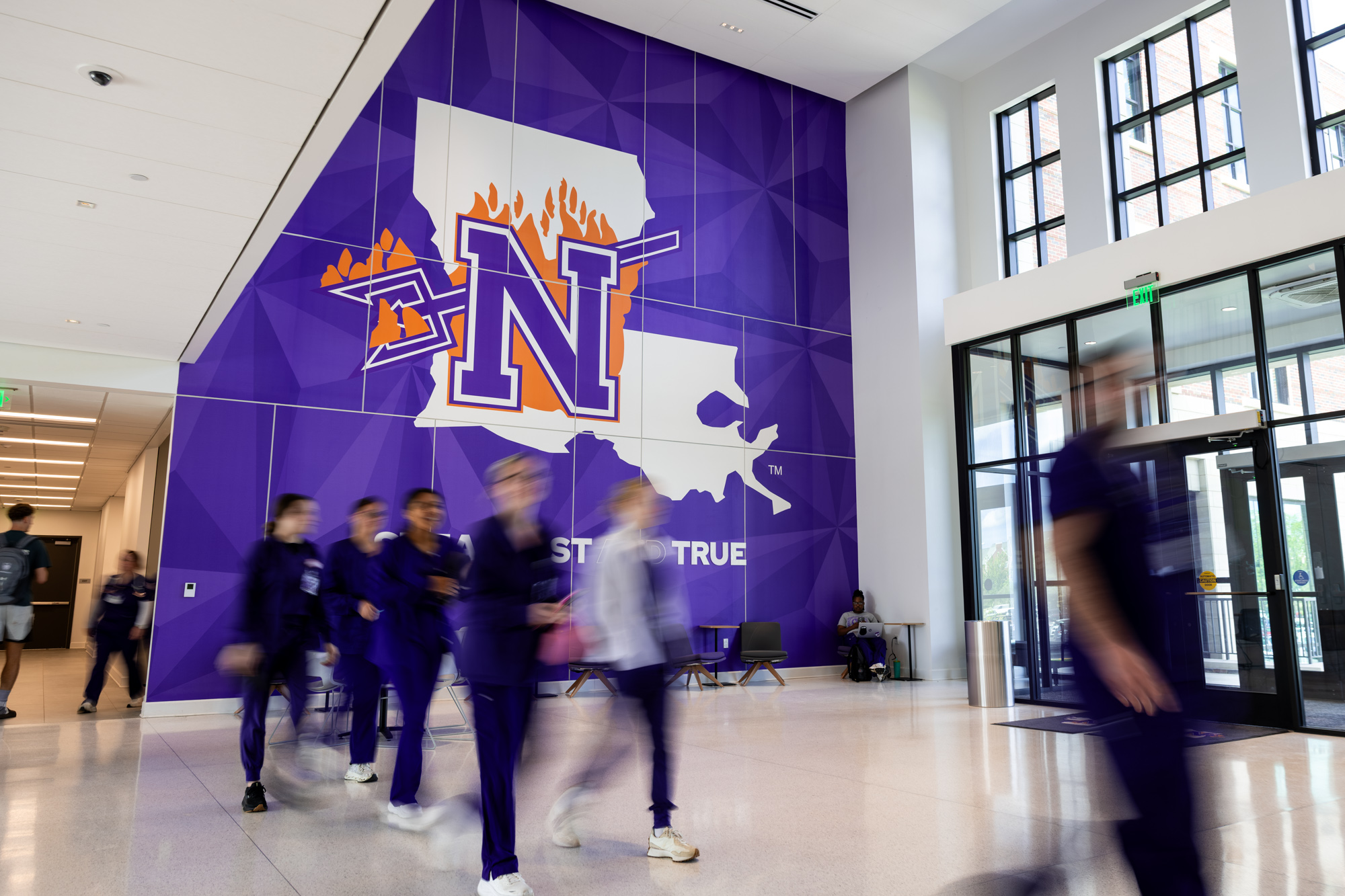 students walking in Alost Hall