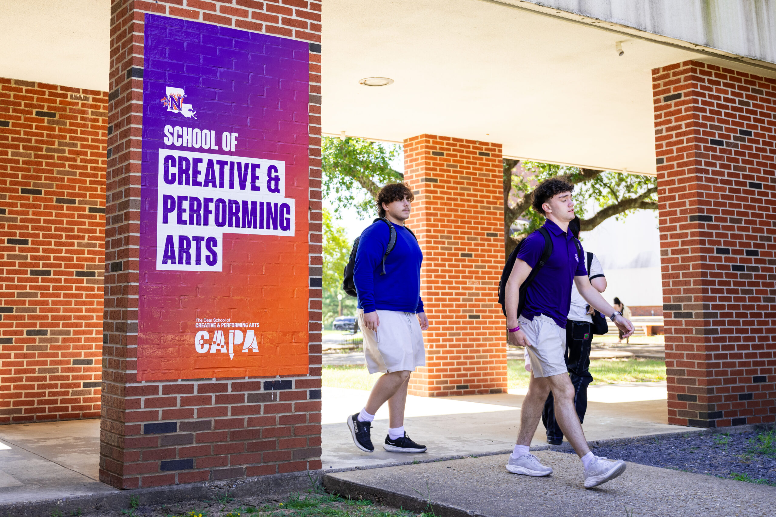 students walking past pillars in the CAPA courtyard