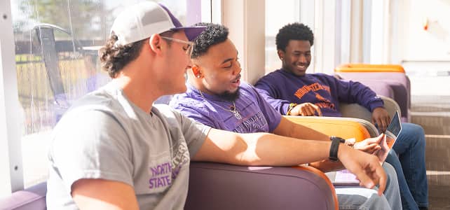 NSULA Students having a conversation at the tables on campus