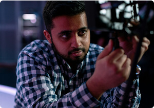 A man examining a computer component.
