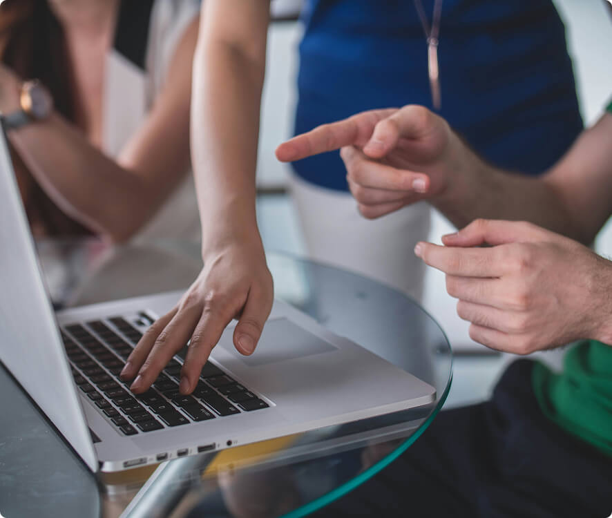 A tight shot of hands above a laptop.