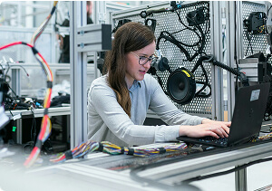 A woman working at a computer.