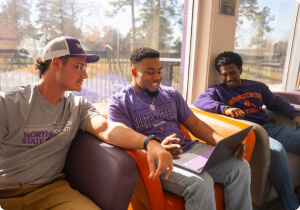 Three students sitting and studying together.