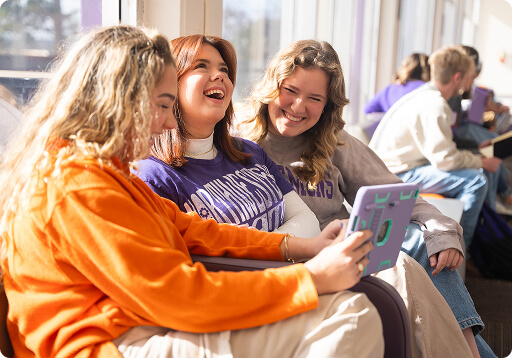 Students reading and laughing together.