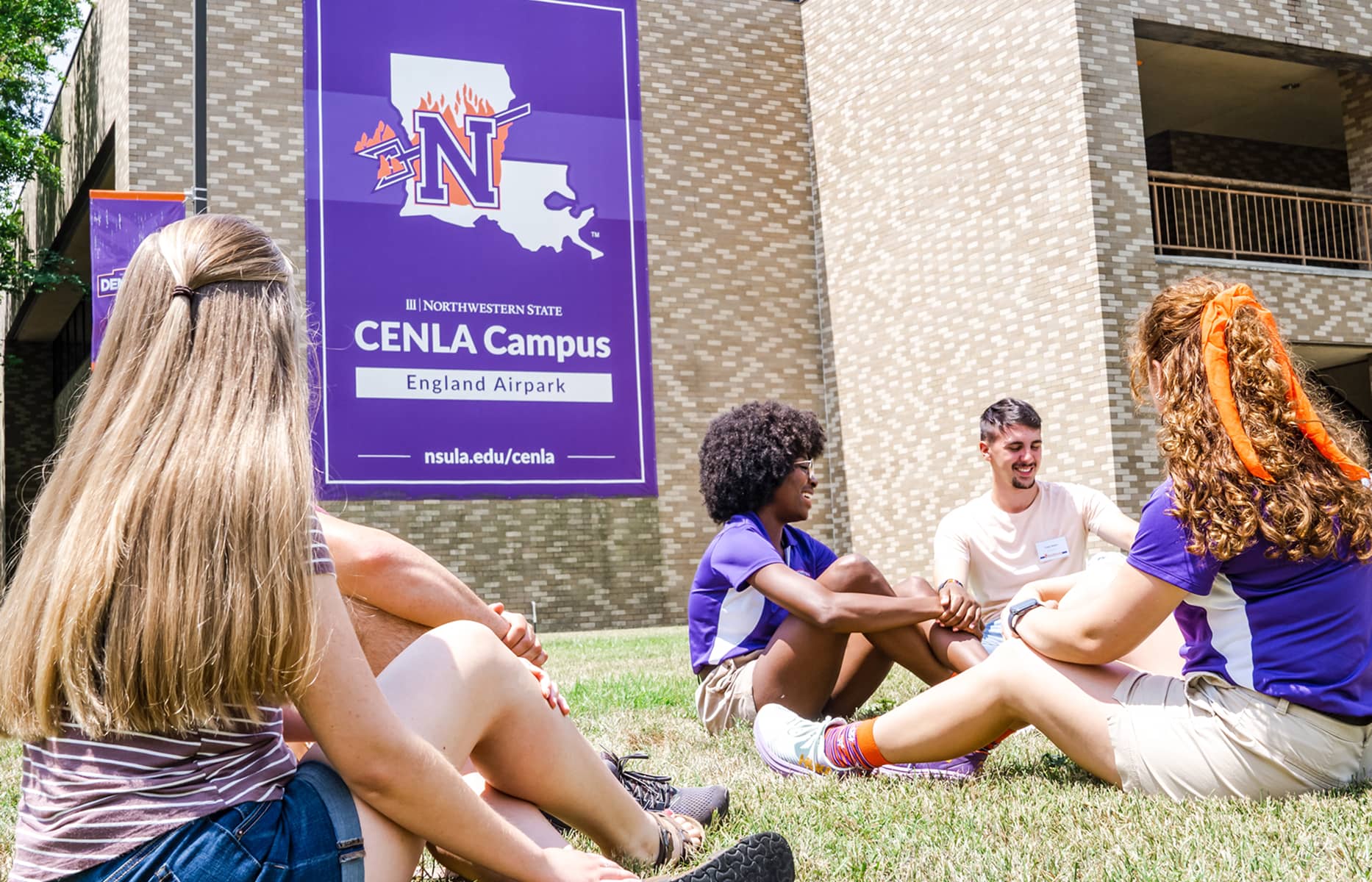 A group of NSU students in the lawn outside of the CENLA Campus