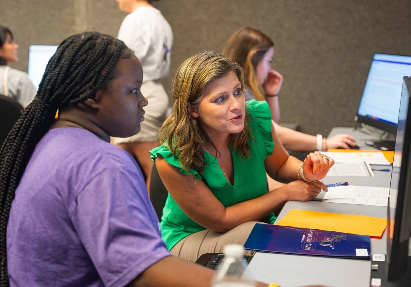 Nursing instructor assist student with class registration