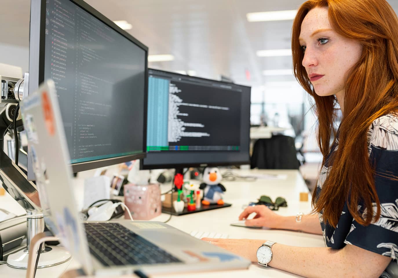 A Student analyzes coding on computer screen
