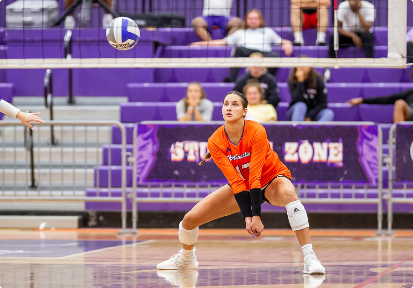 A student playing volleyball.