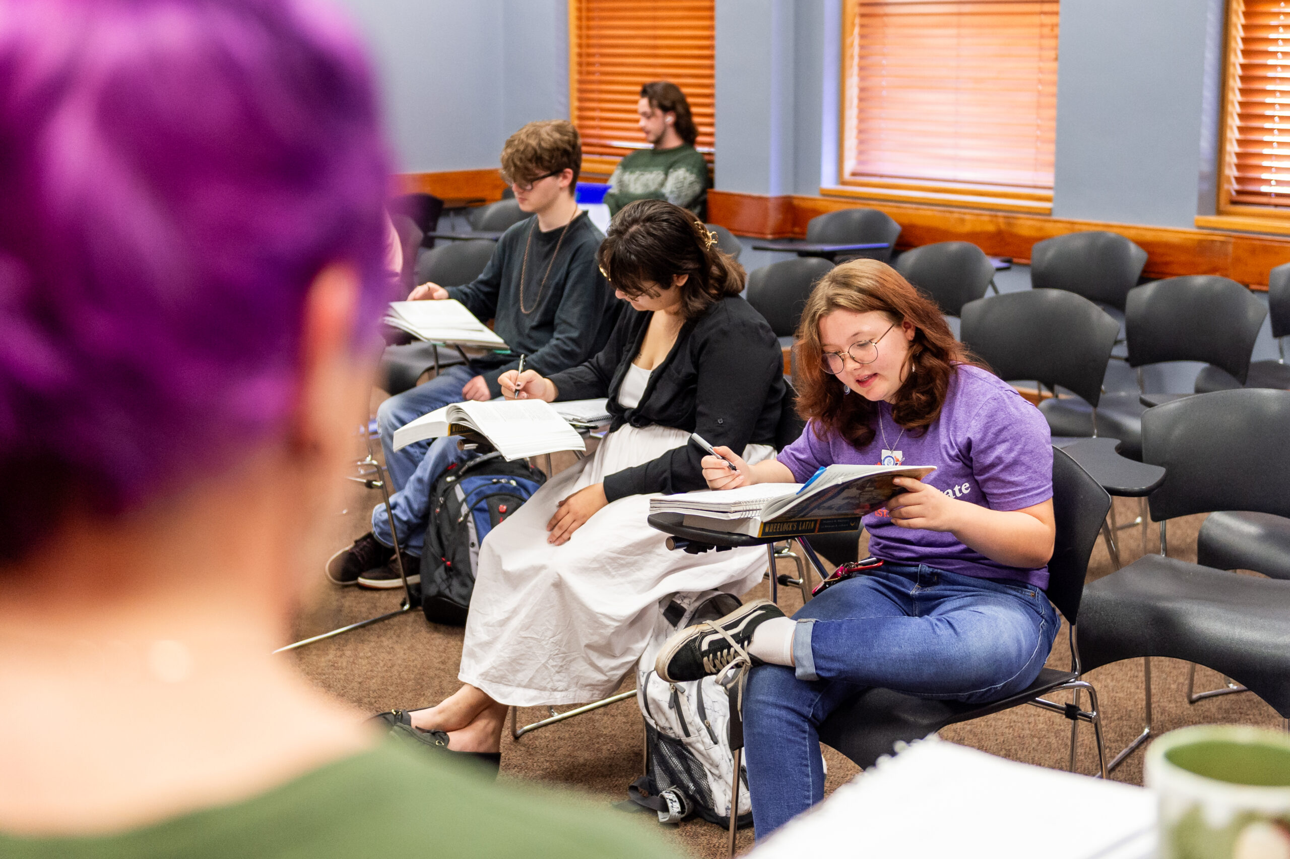 NSU students read a book in classroom