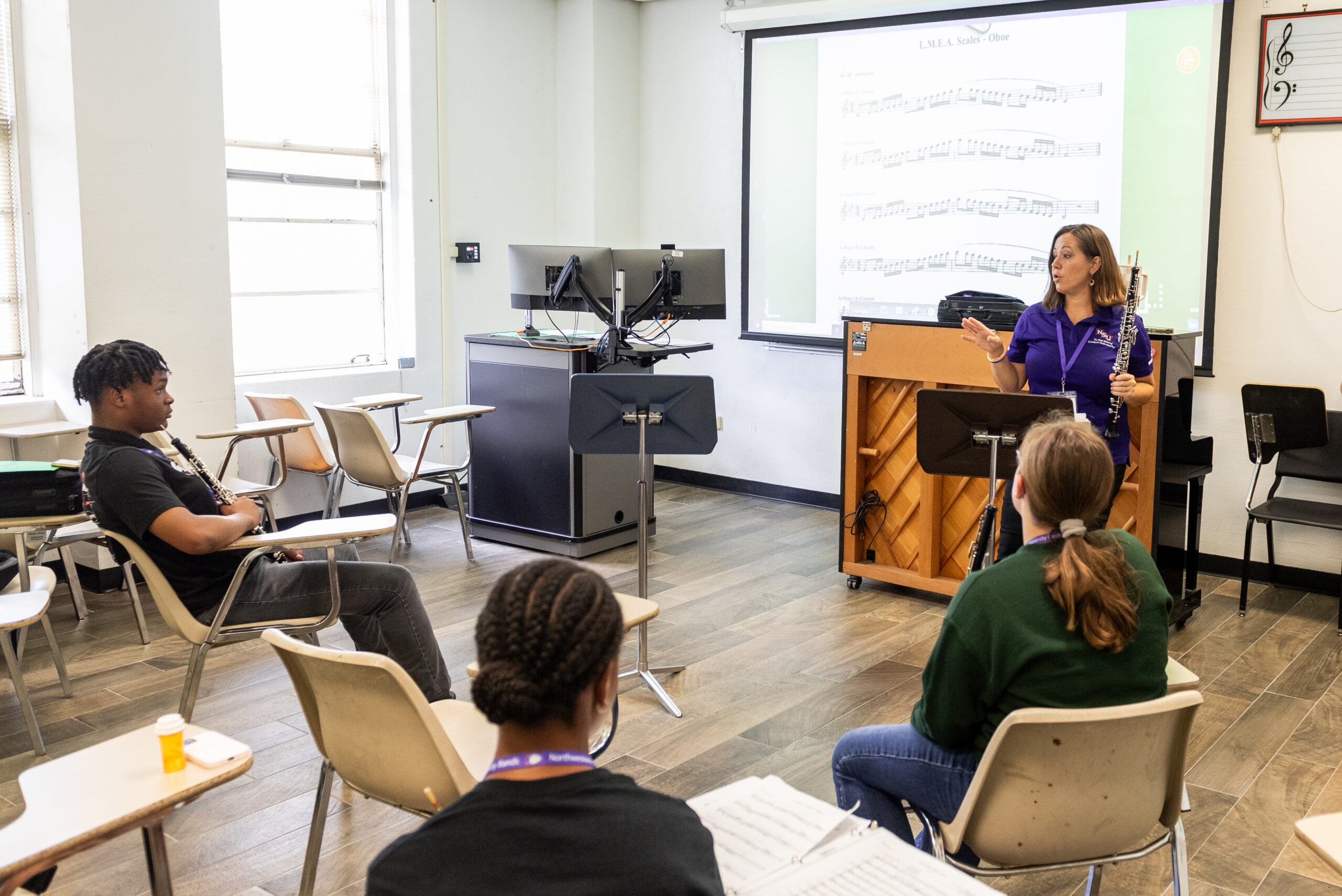 NSU Music instructor helps students during rehearsal