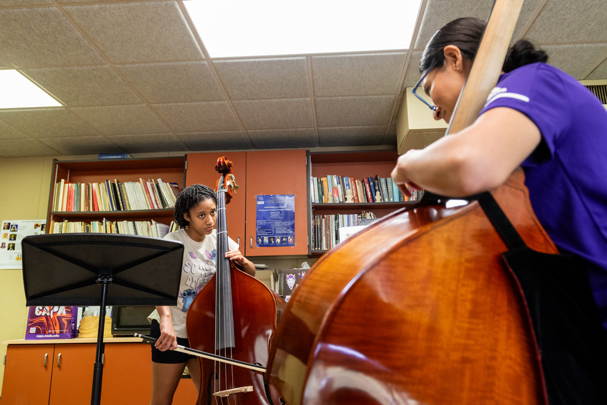 A Music student watches as instructor demonstrates