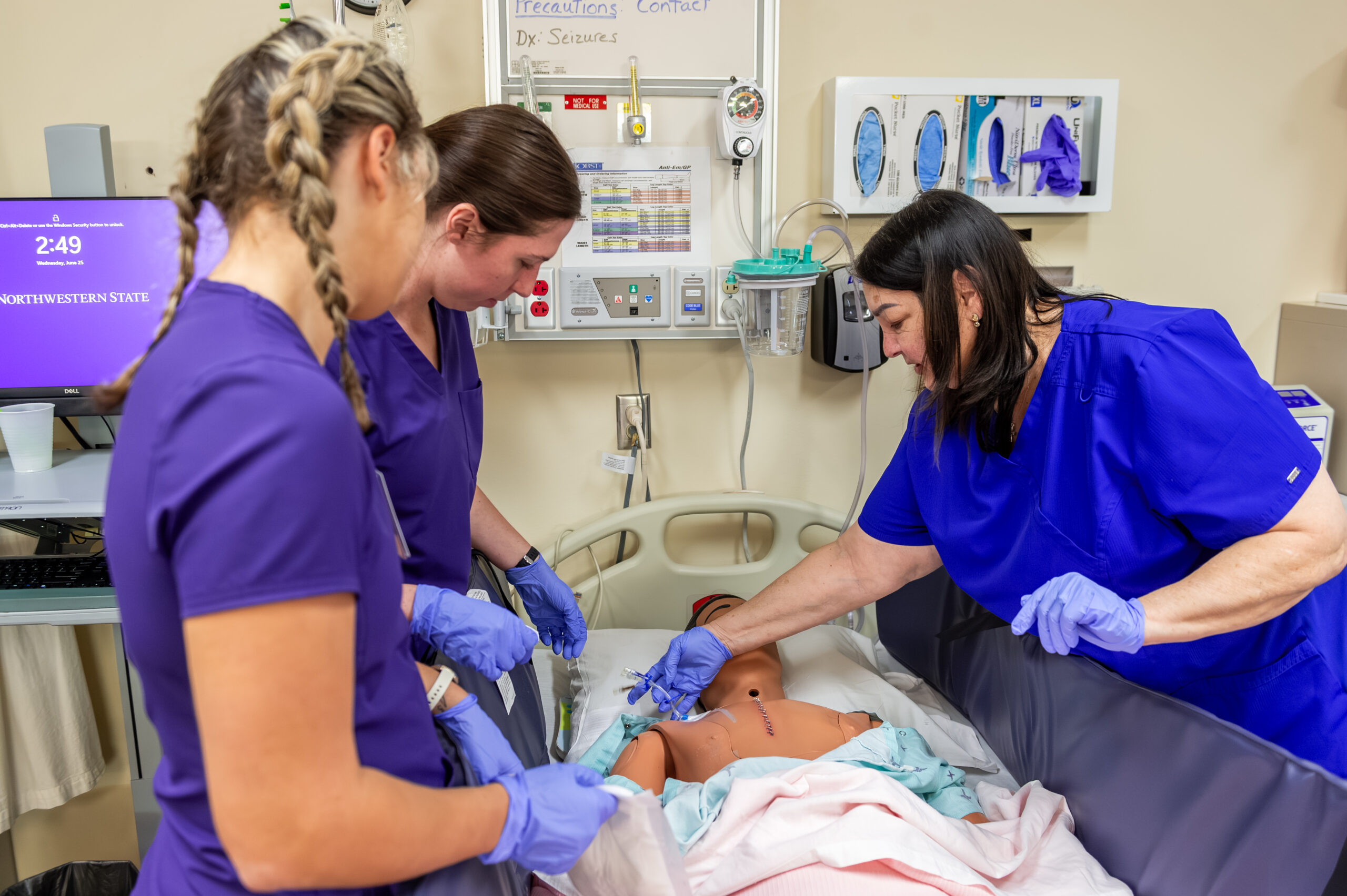 NSU Nursing students learn from instructor in hands-on lab
