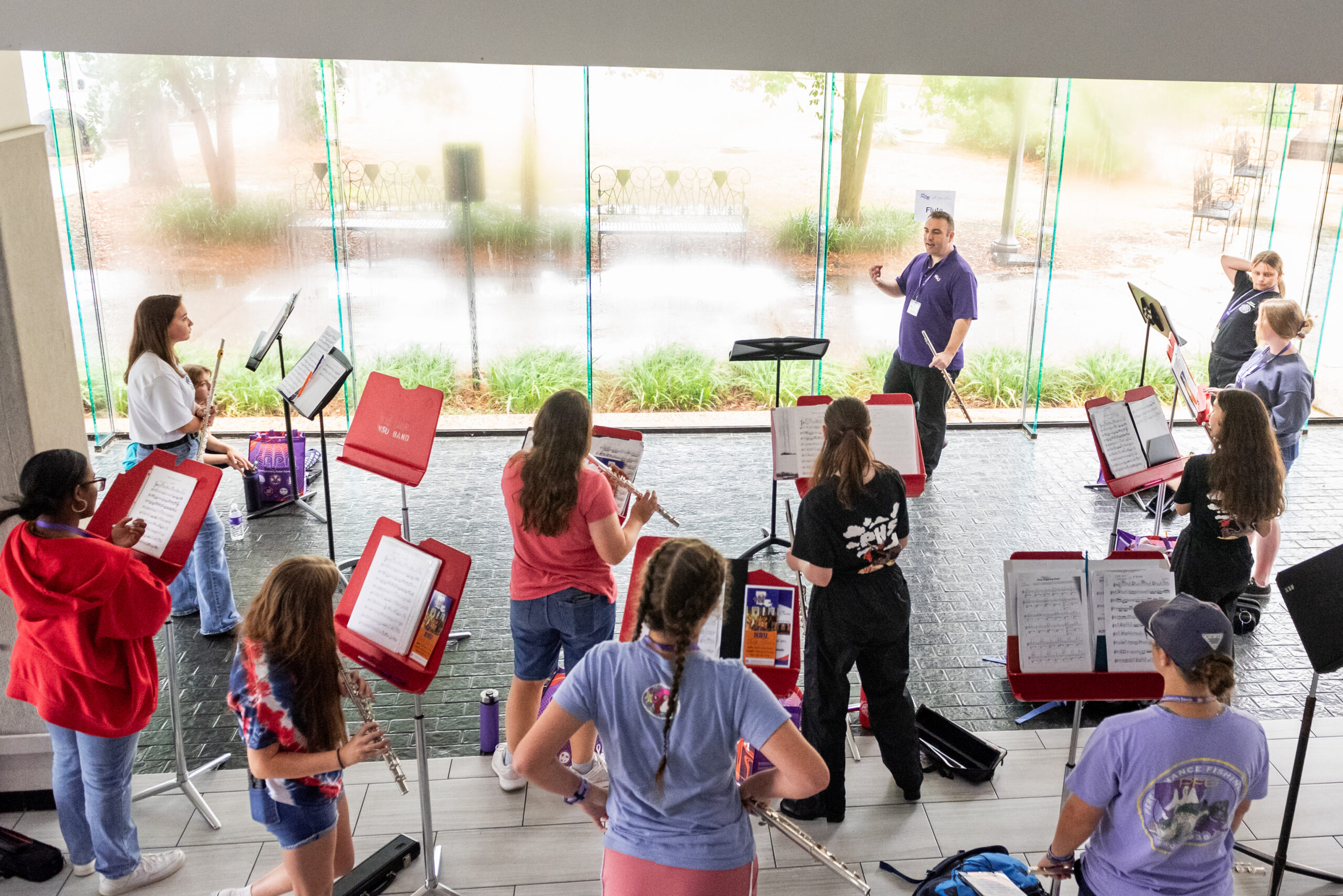A group of NSU Music campers listen to an instructor during a sectional rehearsal