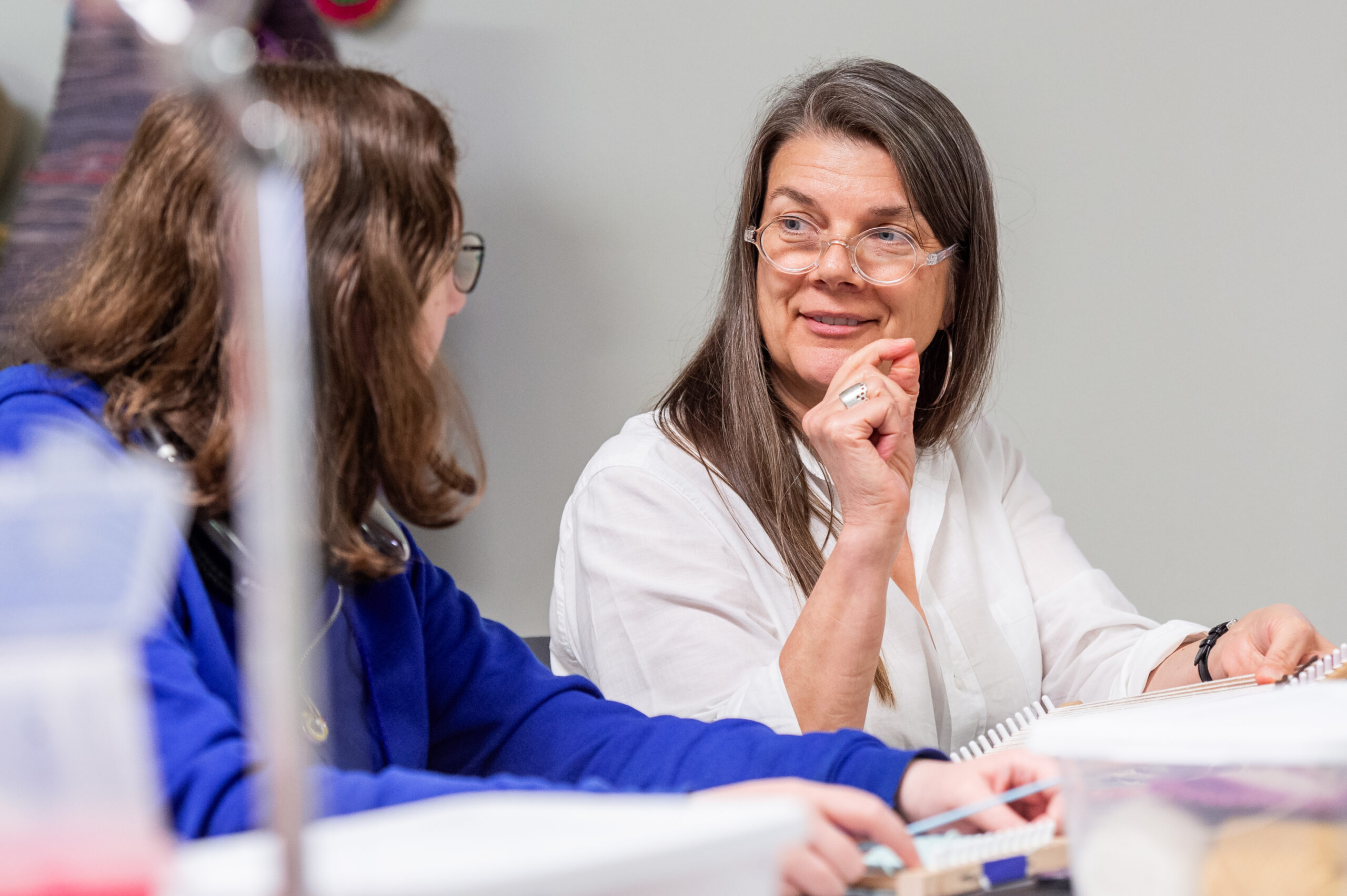 NSU instructor helps student during art project