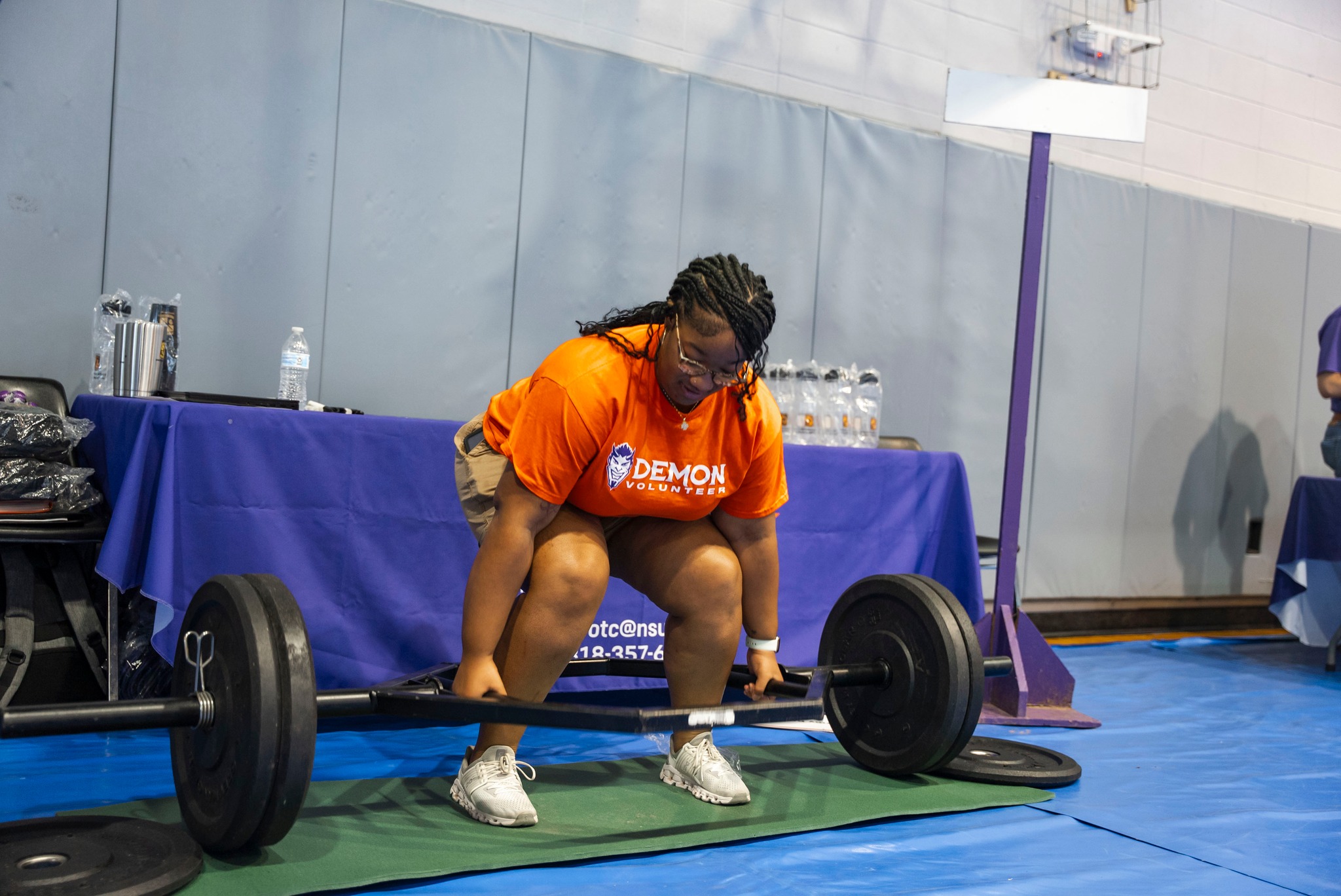NSU students lifts a barbell during an activity at Wellness Fest
