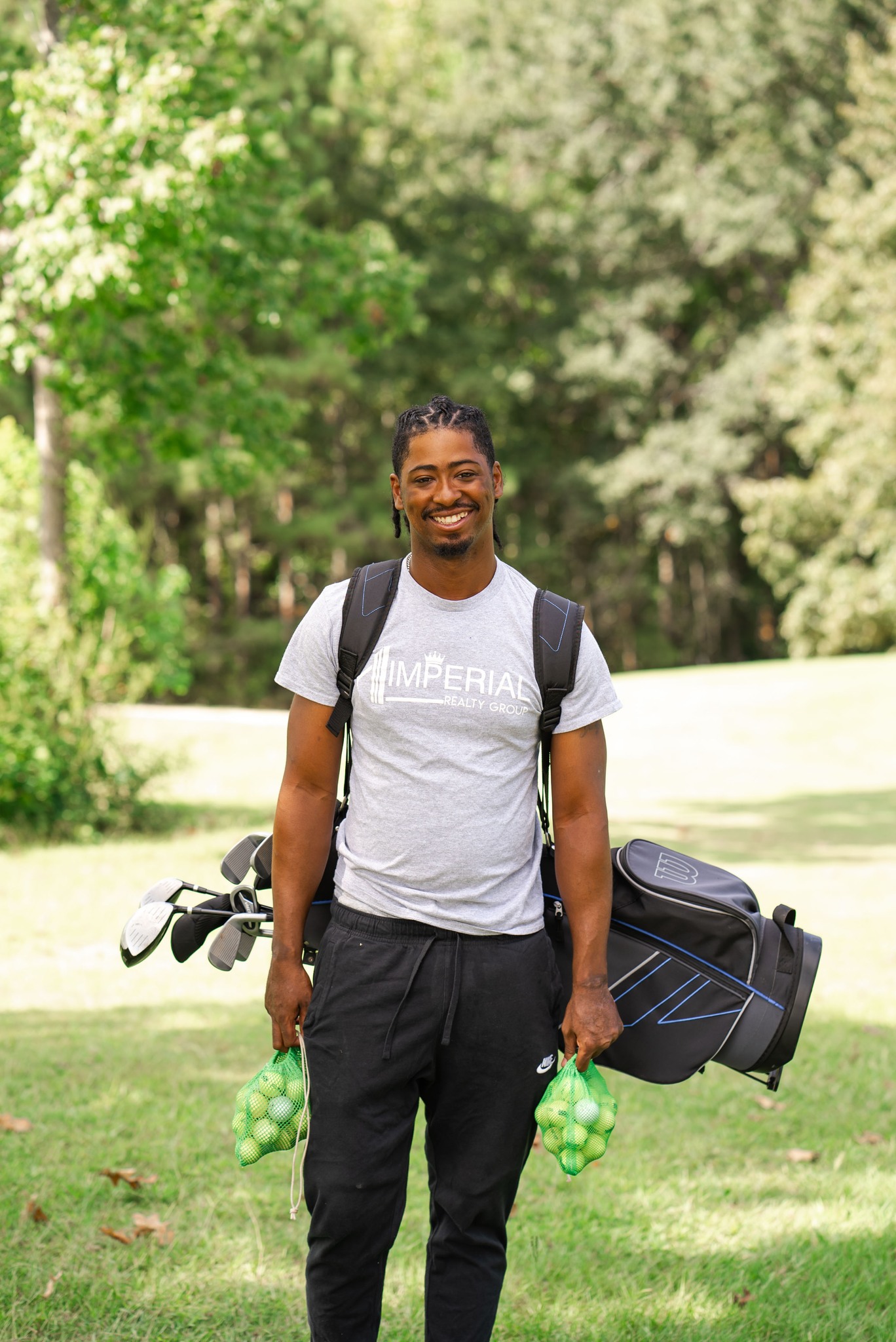 An NSU student smiles for a photo on the golf course
