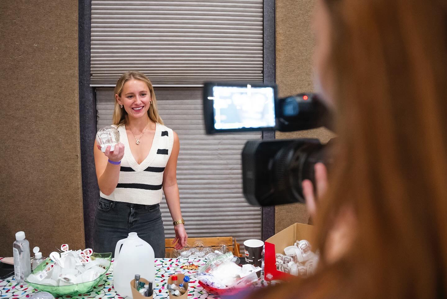 NSU student holds a snow globe at a Christmas event in the Student Union.