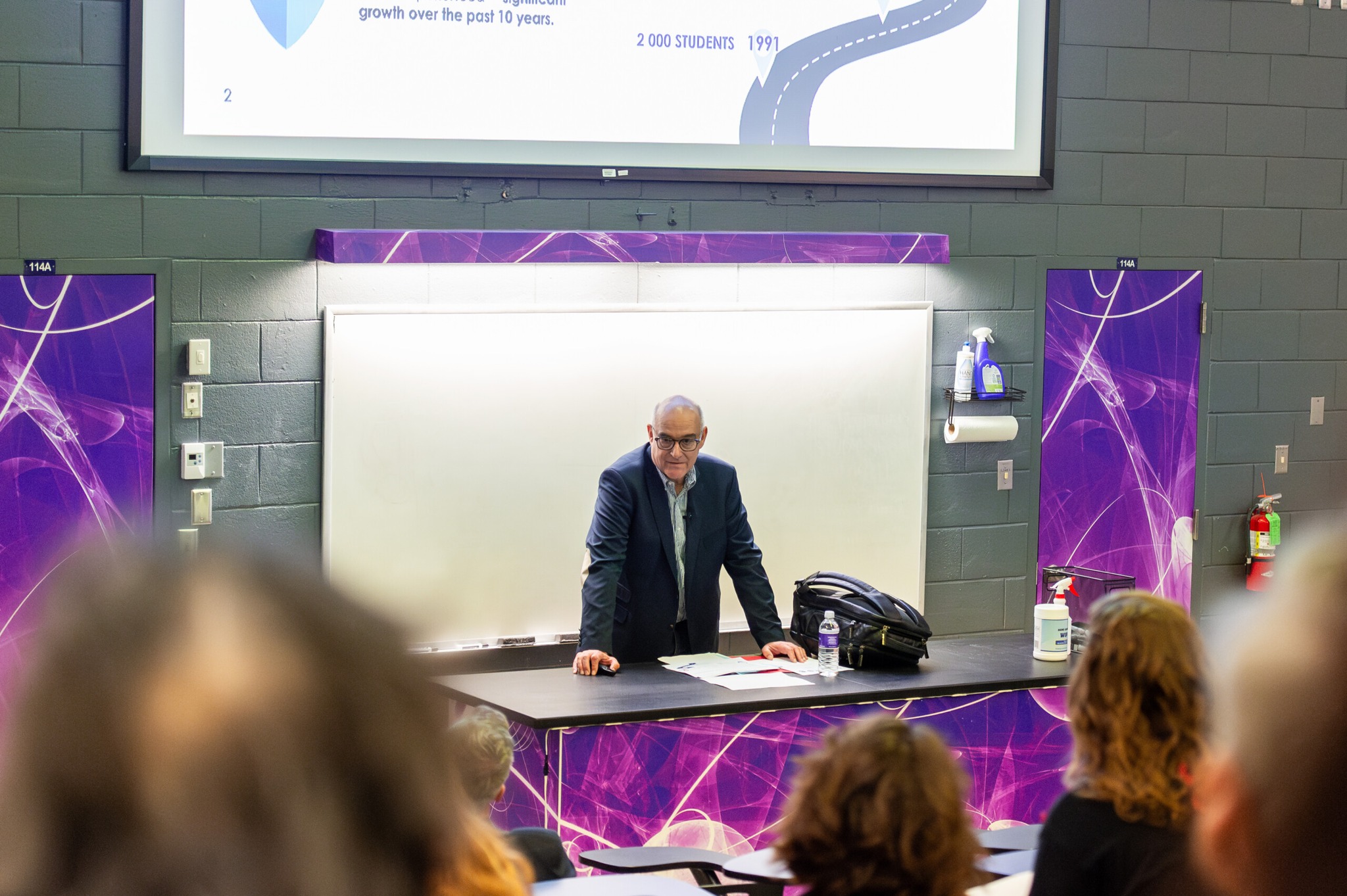 NSU instructor stands before class in Biology lecture hall