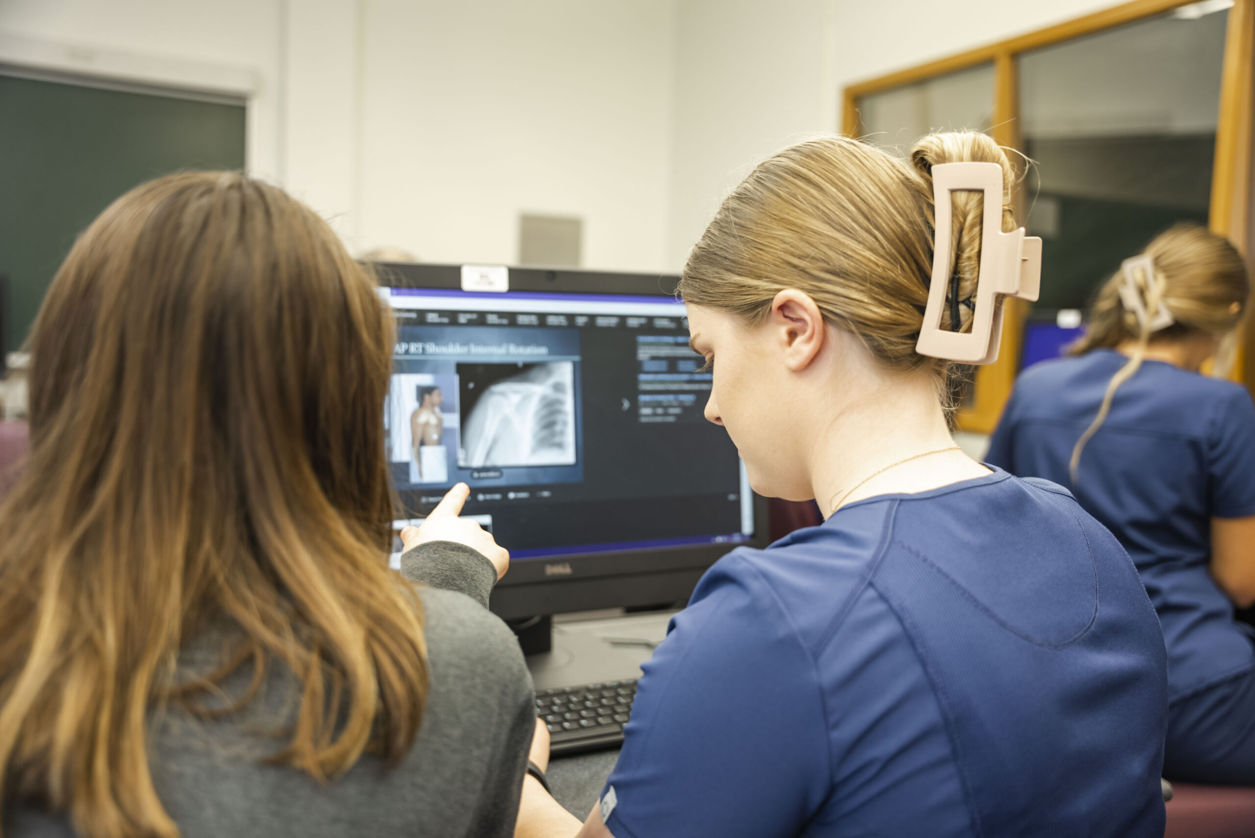Allied Health students learning material in a computer lab