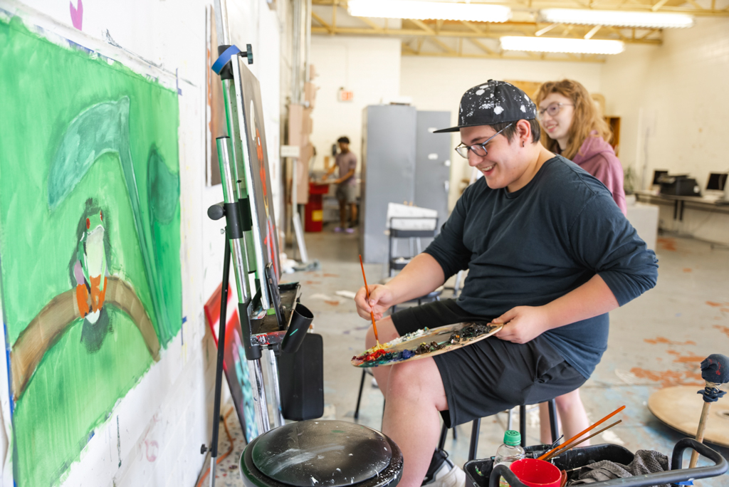 NSU Art students paint on canvas