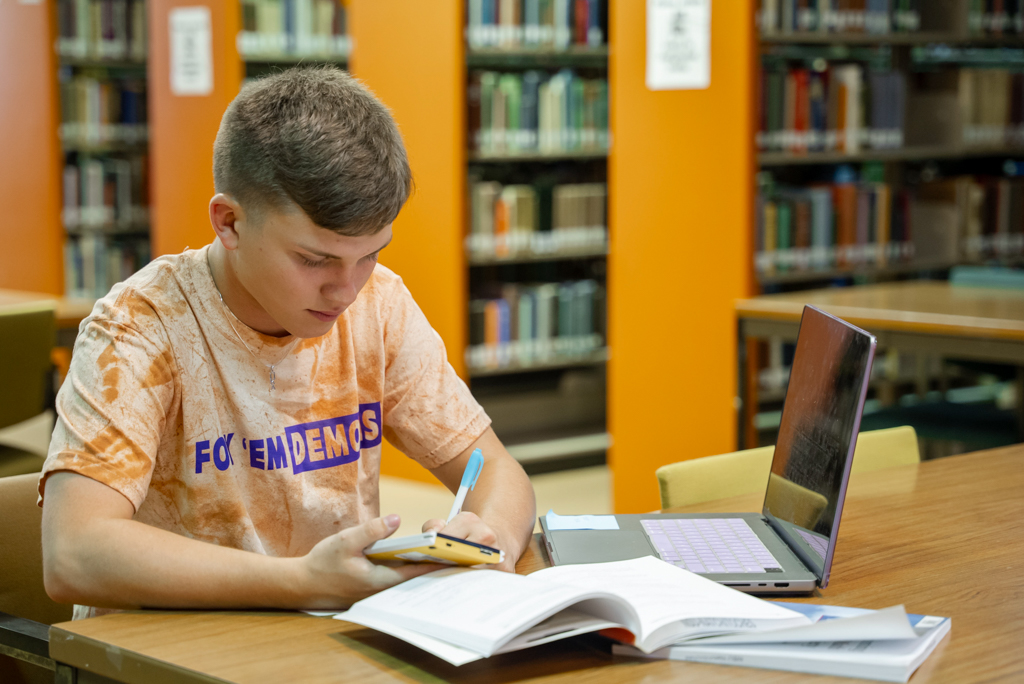 NSU student completing math homework in the library
