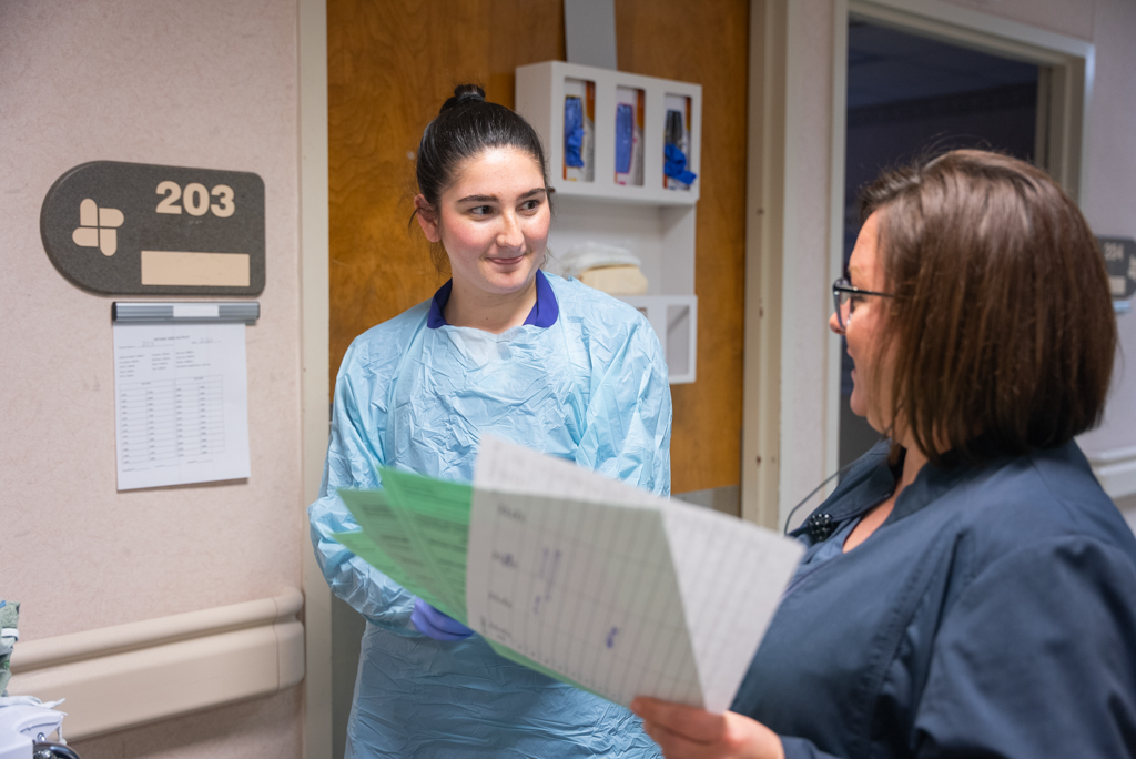 Hospital nurse assists NSU nursing student