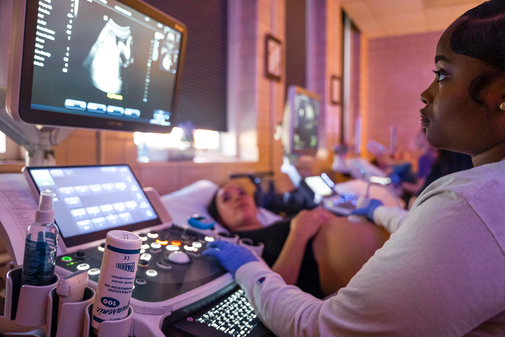An NSU sonography student performing an ultrasound