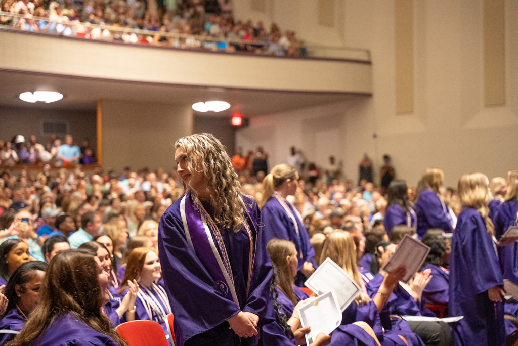 NSU Nursing graduate stands at a pinning ceremony