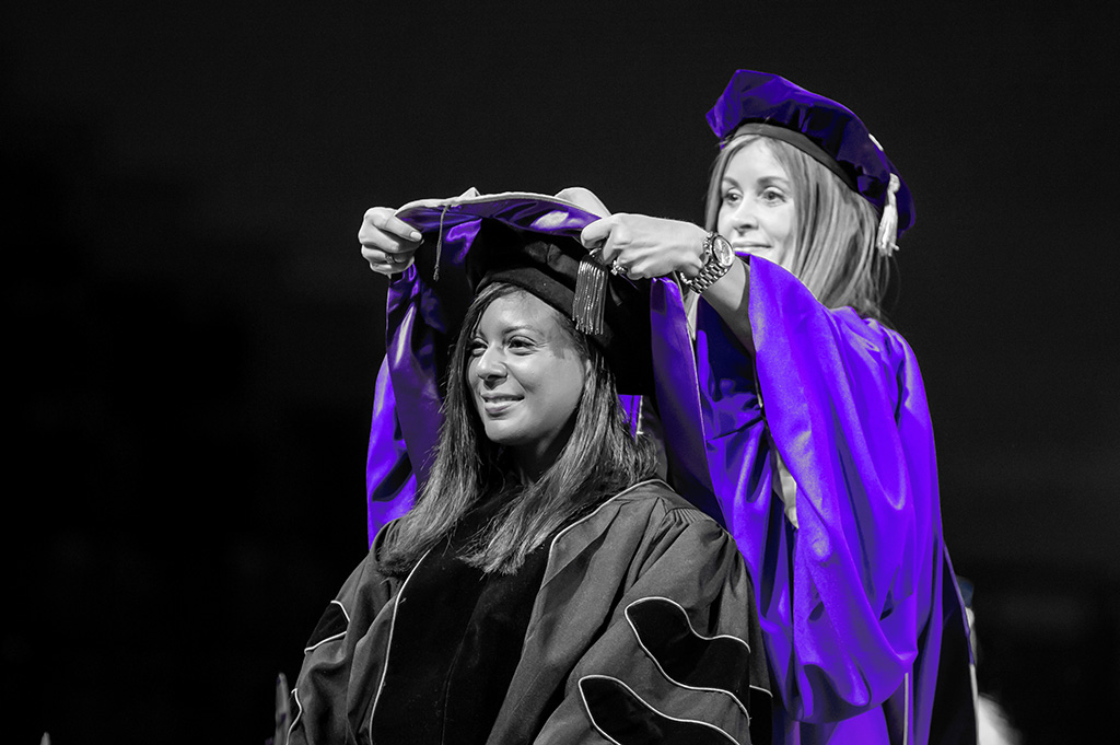 DNP nursing student receives hood from CONSAH Dean Dr. Aimee Badeaux.