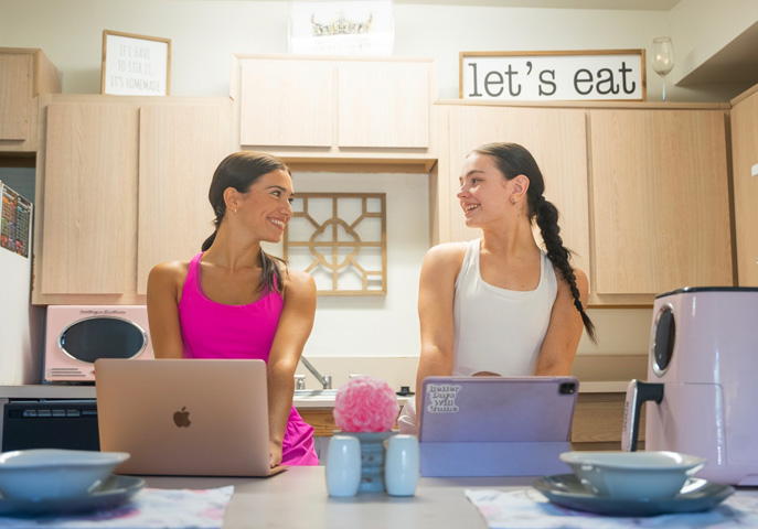 Two NSU students enjoying their dorm rooms on campus.