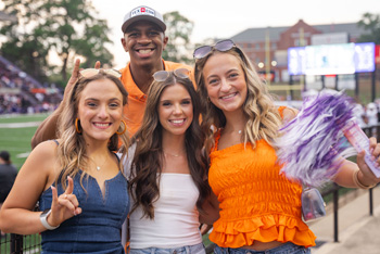 NSU students at football game cheering on the demons.