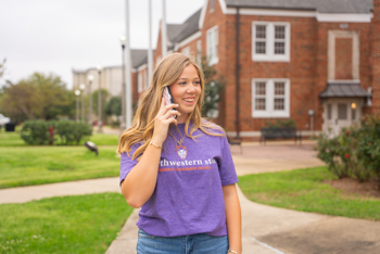 NSU student talking on the phone on campus.