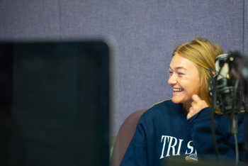 NSU student in sound/audio booth recording sessions