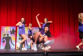 NSU students dance on stage during Homecoming Week.