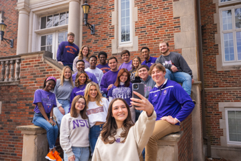 A group of NSU students take a selfie outside of Russell Hall