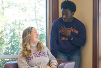 NSU students have a conversation in the Student Services lobby