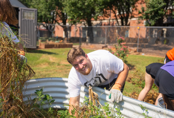 NSU student planting vegetables at NSU eLab School.