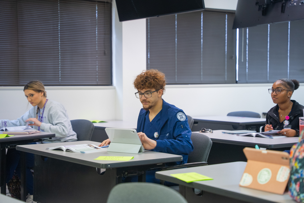 NSU Nursing students listen to instructor in class