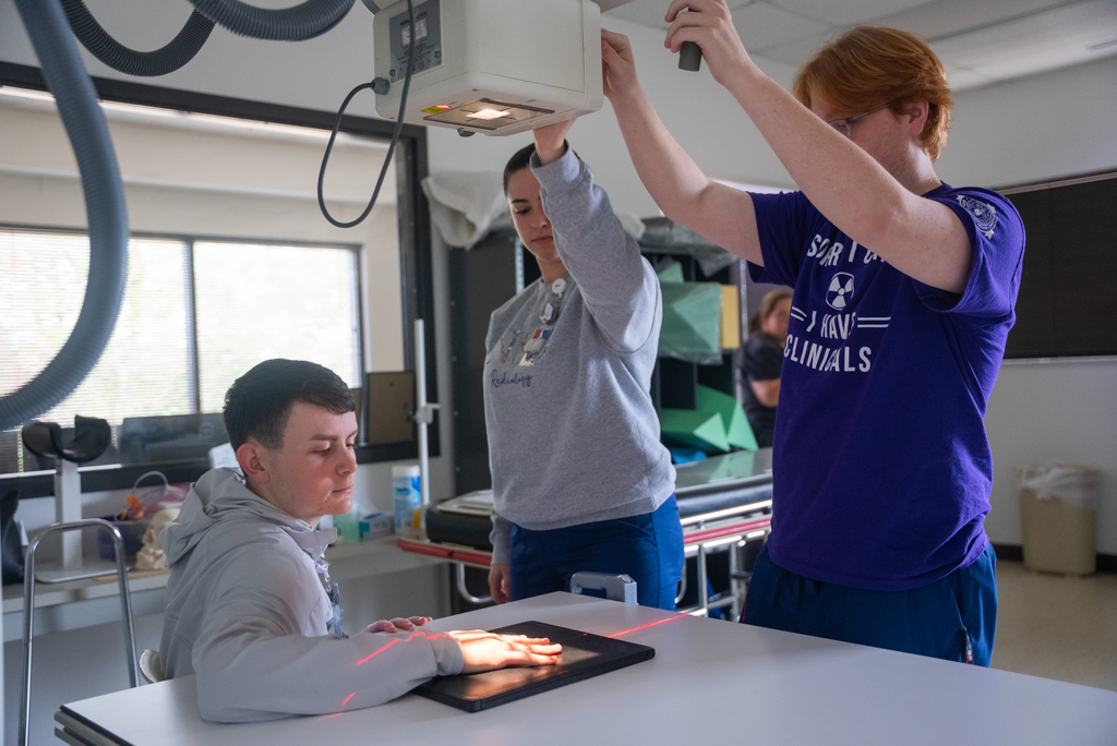 A group of NSU students perform an x-ray scan of a hand