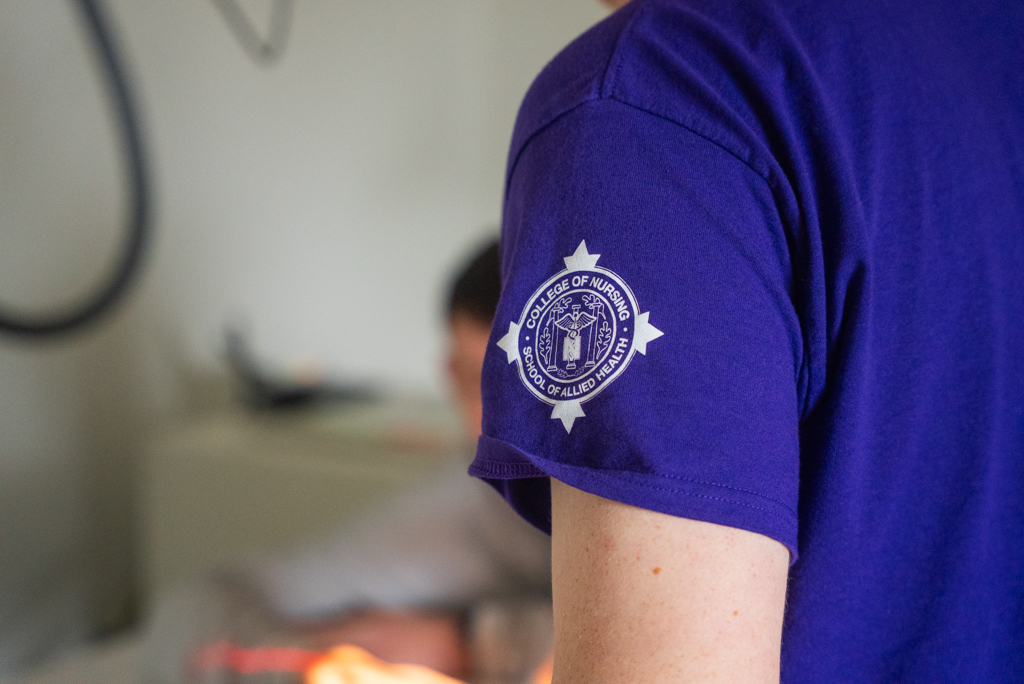 NSU College of Nursing and School of Allied Health emblem on scrub sleeve