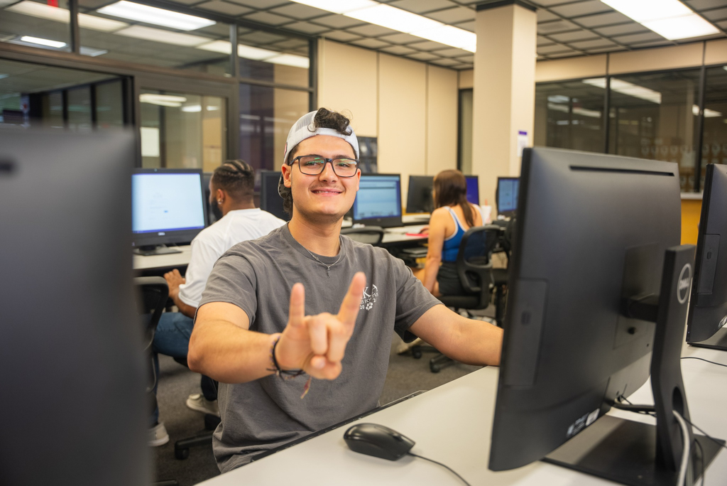 NSU Student poses for a photo in the computer lab