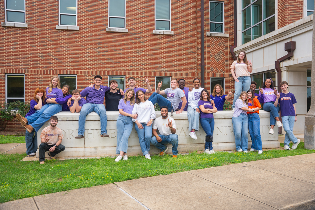 A group of NSU students gather outside the Student Services Center