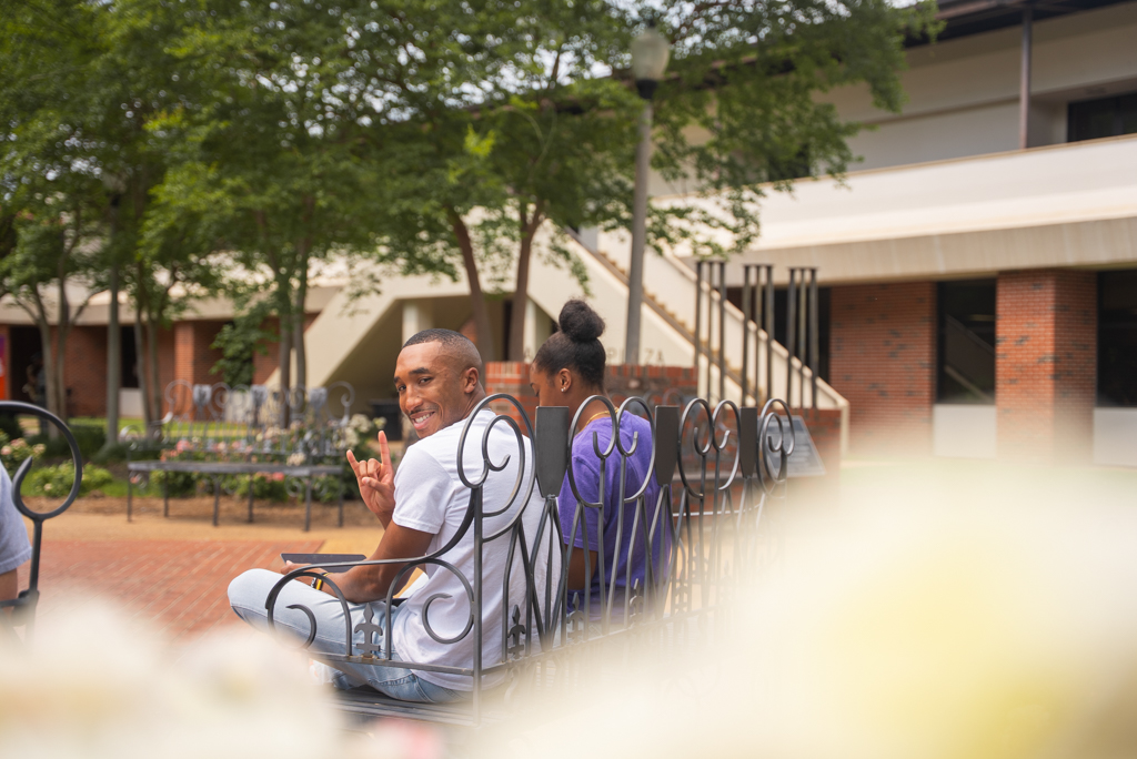NSU student poses for a photo in the Alumni Plaza