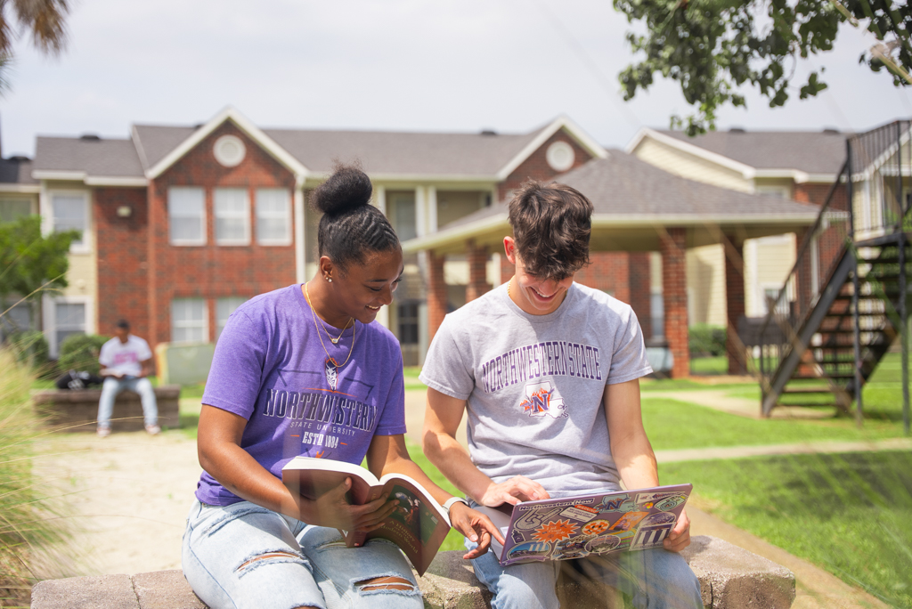 NSU students doing schoolwork outside of their residence hall