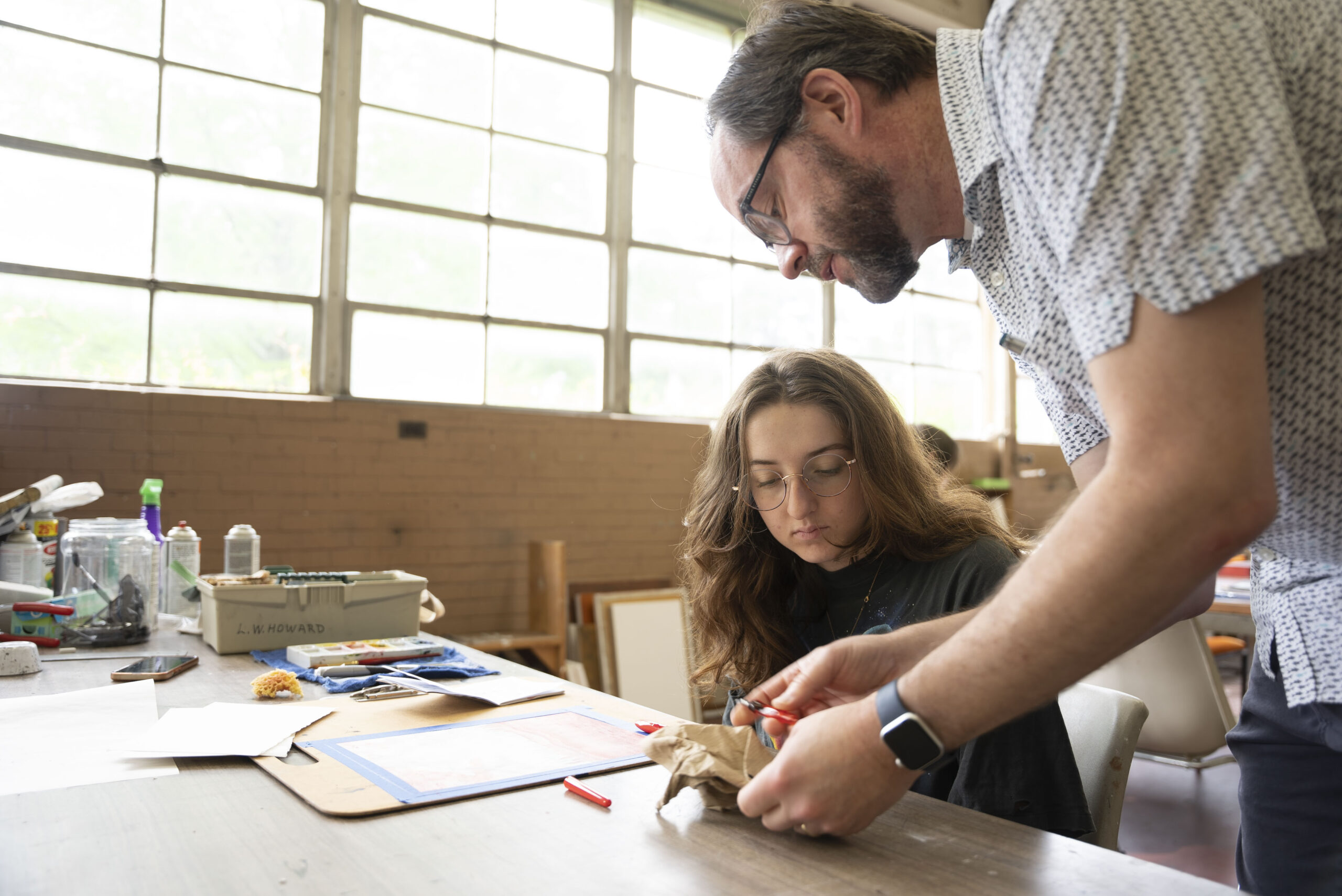 NSU instructor helps student with Fine Arts design