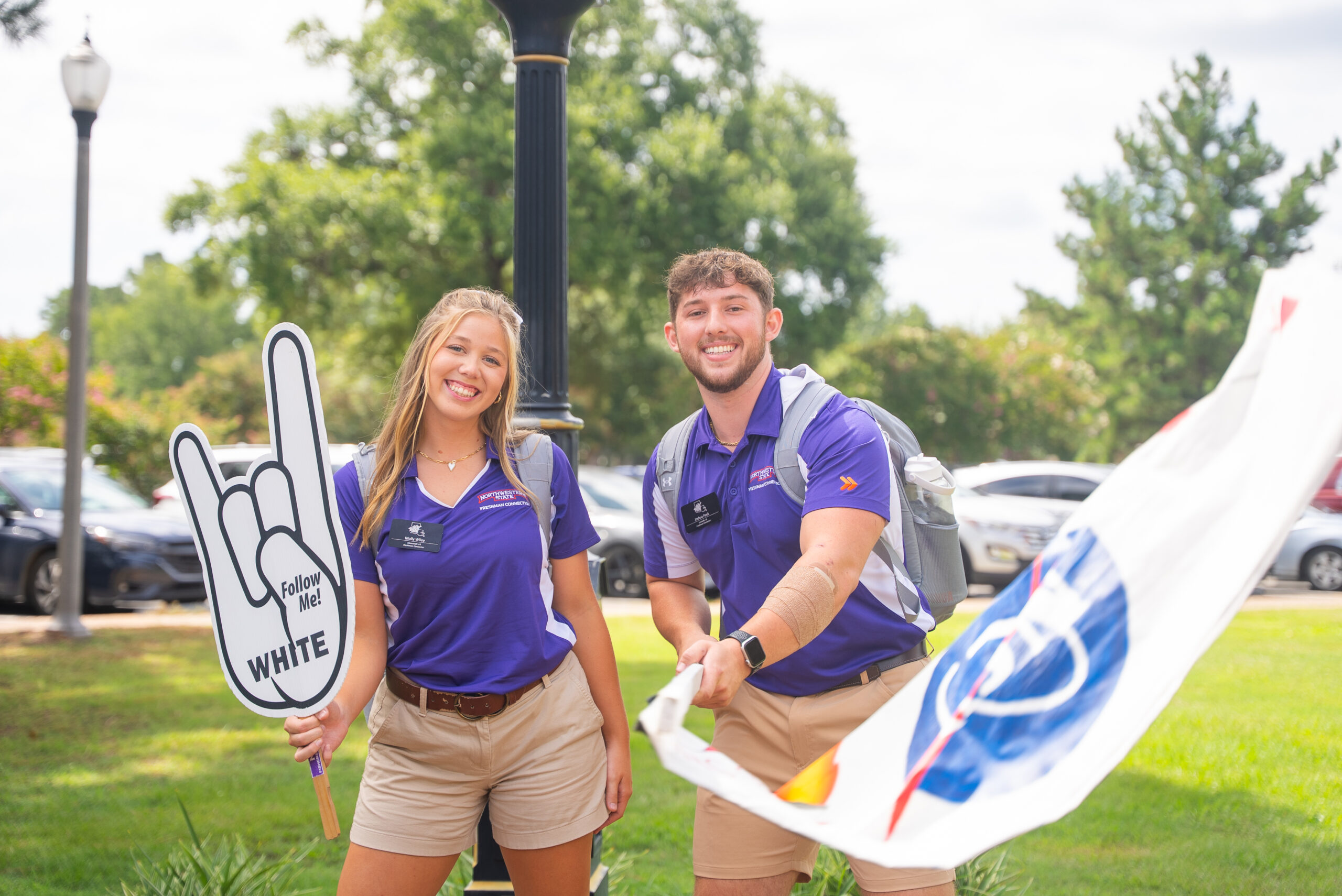 NSU Freshman Connectors pose for a photo with their team flag
