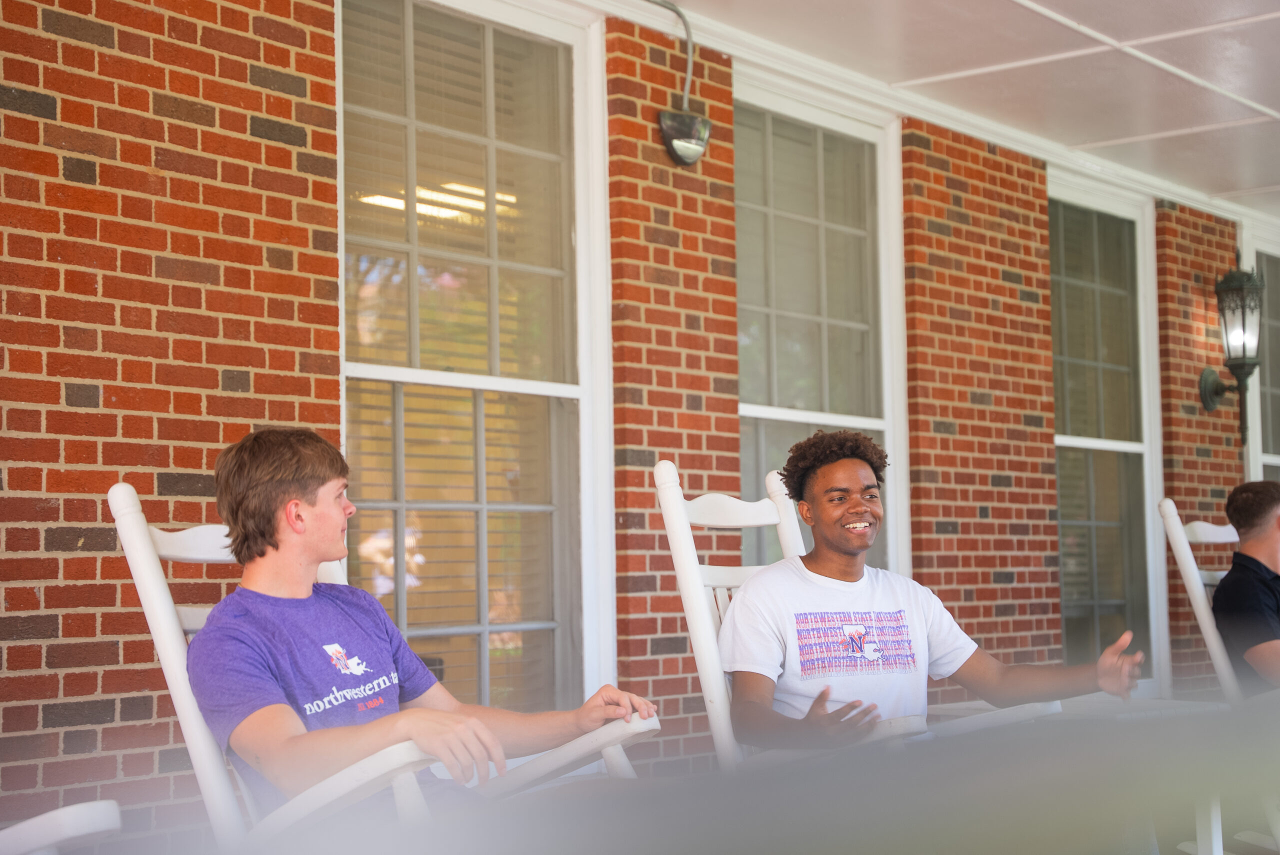NSU students sit on the front porch of Varnado Hall