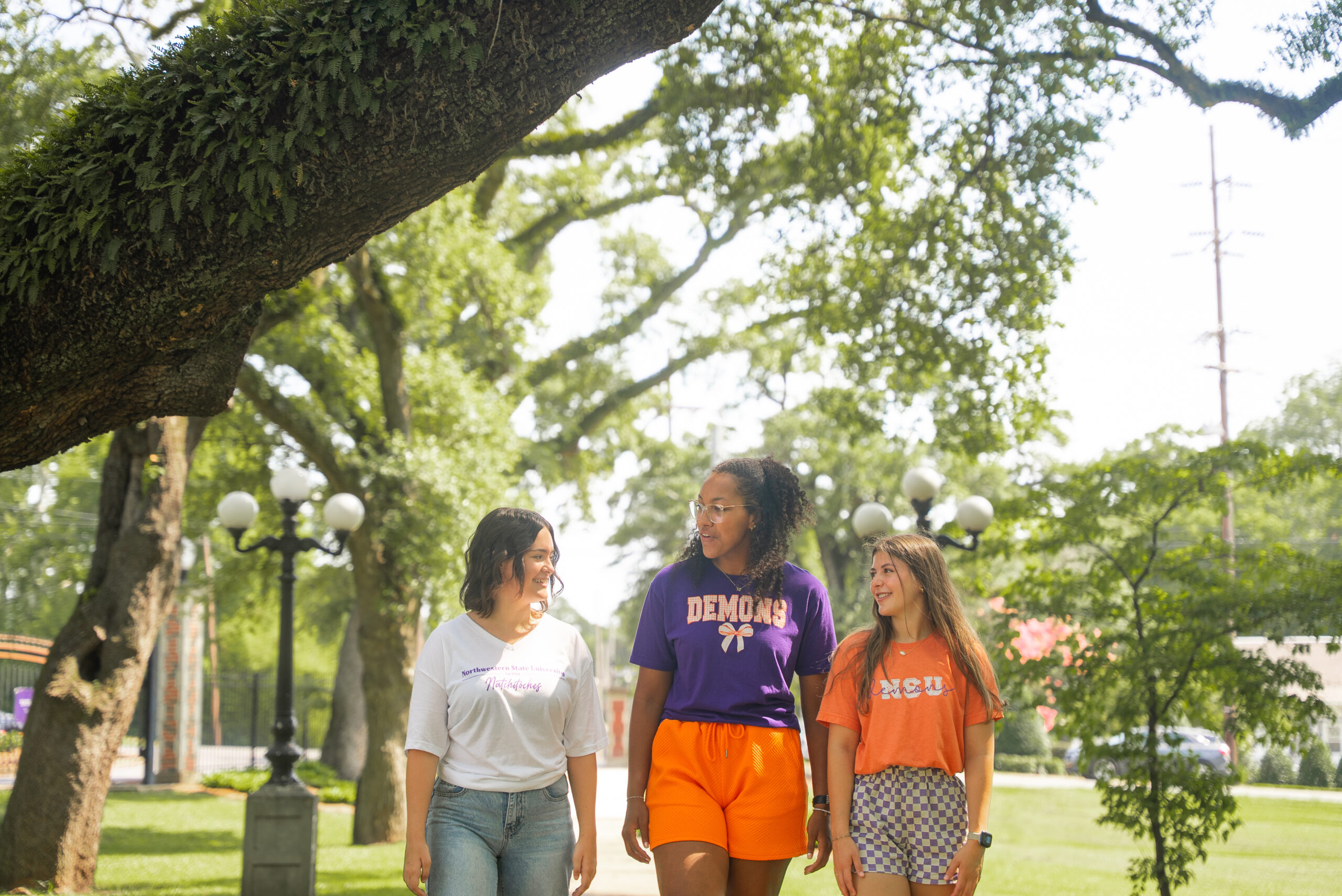 NSU students walk down sidewalk on campus