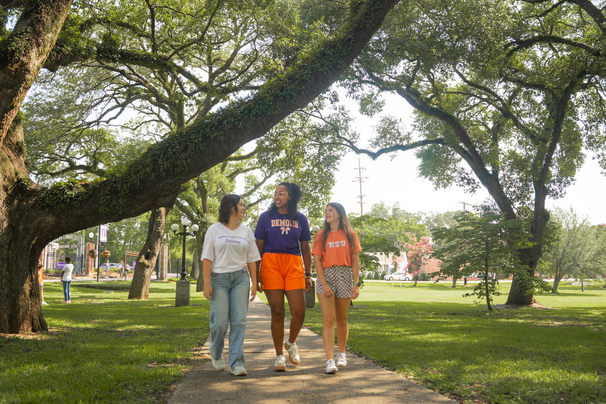 NSU students walk down sidewalk on campus