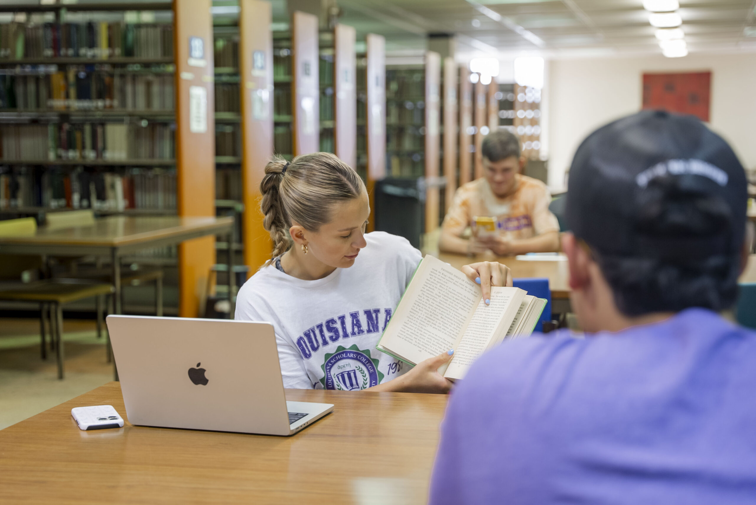 A group of students doing homework in the library